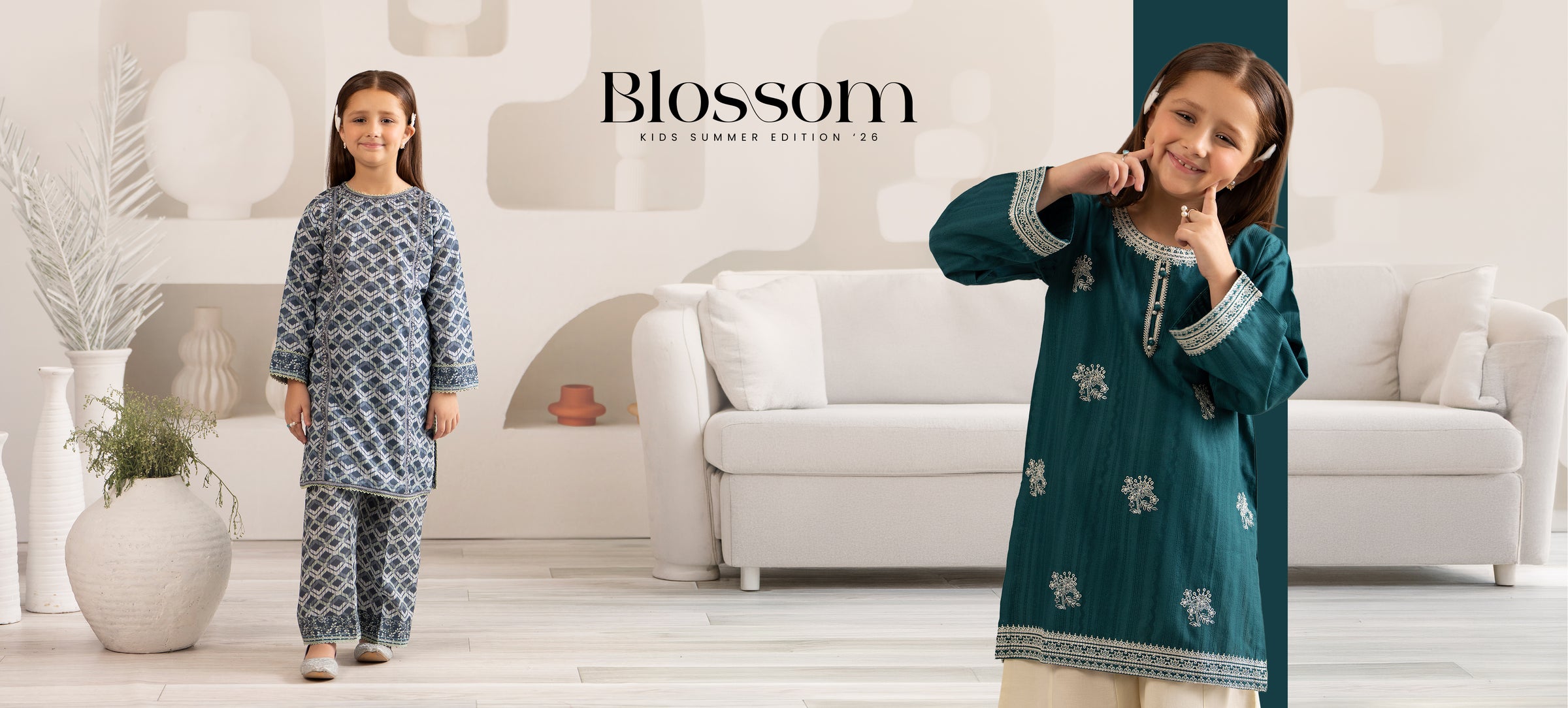 Two children modeling outfits with 'Blossom' branding in a modern living room setting.