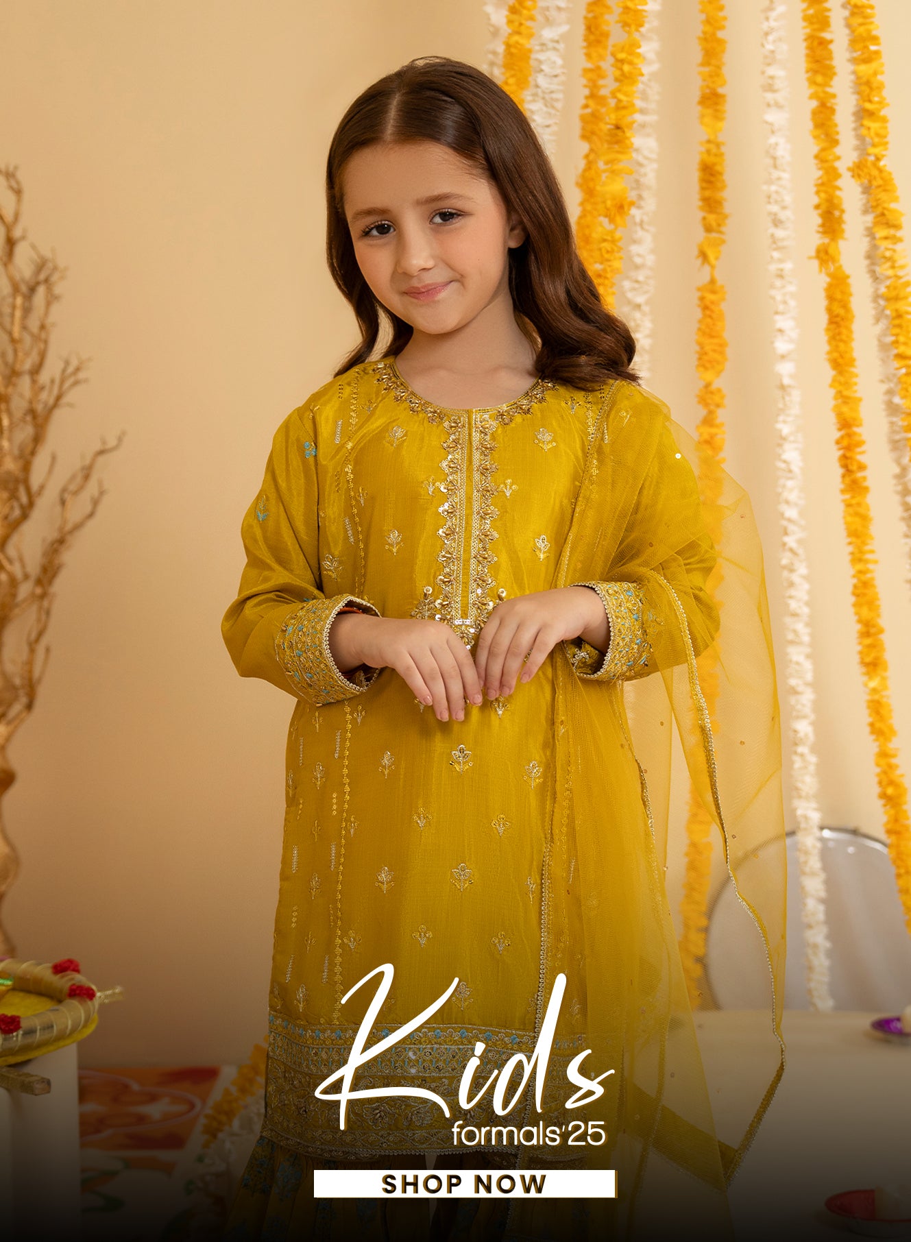Young girl in a yellow traditional outfit with floral decorations in the background